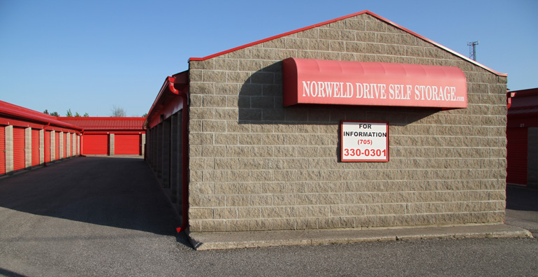 Norweld Drive Self Storage facility with red roof and signage